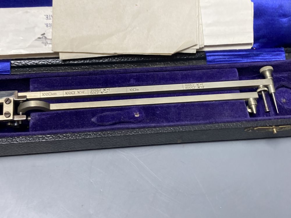 A vintage polished steel planimeter by M.D.S, cased with illustrations